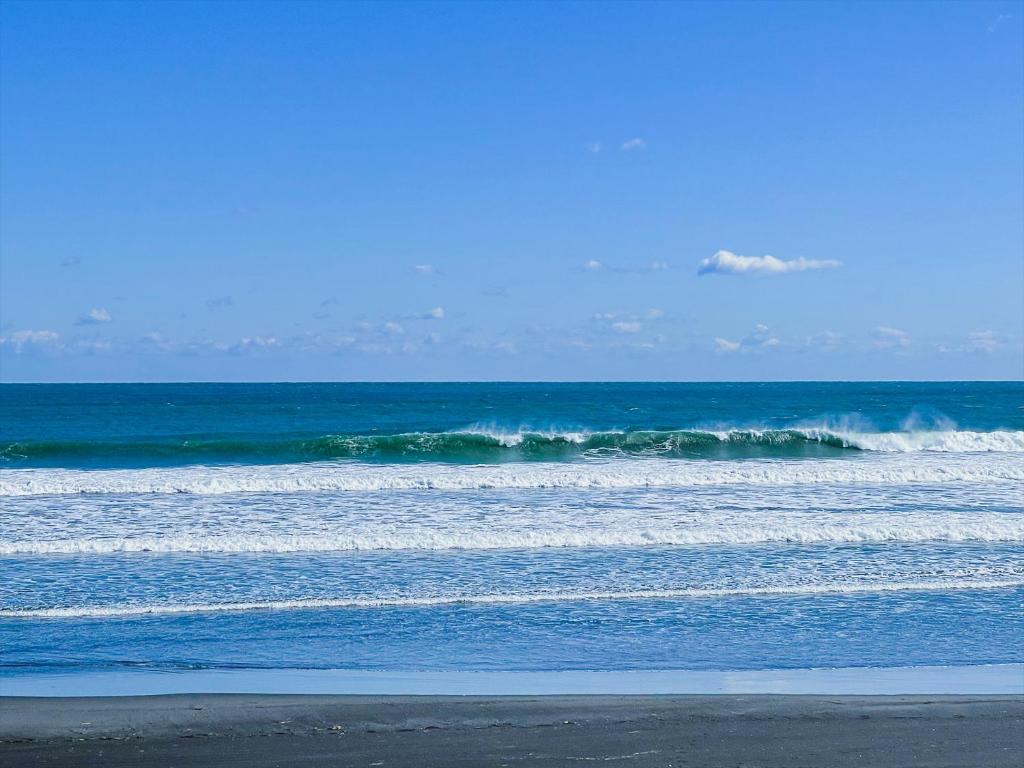 a group of waves in the ocean on a beach at Seage Torami Coastside in Ichinomiya