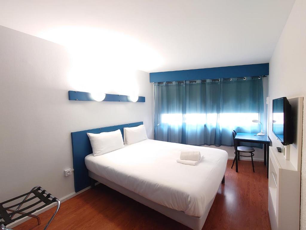 Postel nebo postele na pokoji v ubytování greet hotel Grenoble Centre Gare