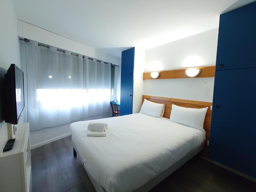 Postel nebo postele na pokoji v ubytování greet hotel Grenoble Centre Gare