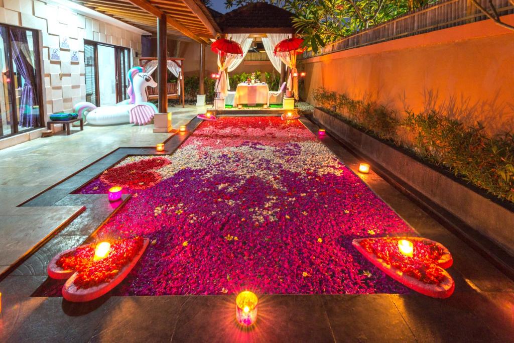 a room with a carpet of red flowers on the floor at Private Pool Villas in Kuta