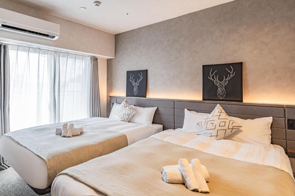 Postel nebo postele na pokoji v ubytování Apartment Hotel 11 Shinsaibashi 2
