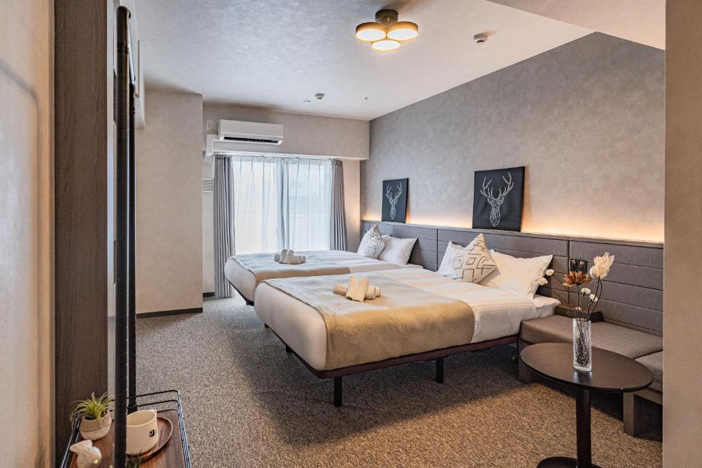 Postel nebo postele na pokoji v ubytování Apartment Hotel 11 Shinsaibashi 2