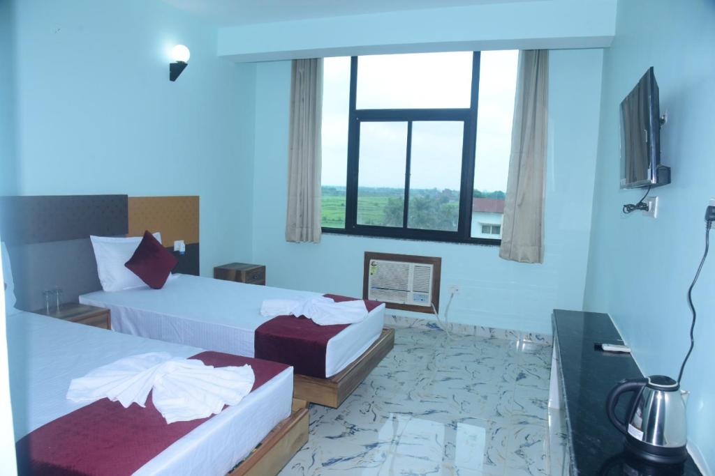 Postel nebo postele na pokoji v ubytování Hotel Gridhakuta International