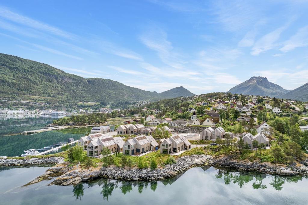 an aerial view of a home on an island in the water at Modern house by the Fjord in Sandane, Nordfjord. in Sandane