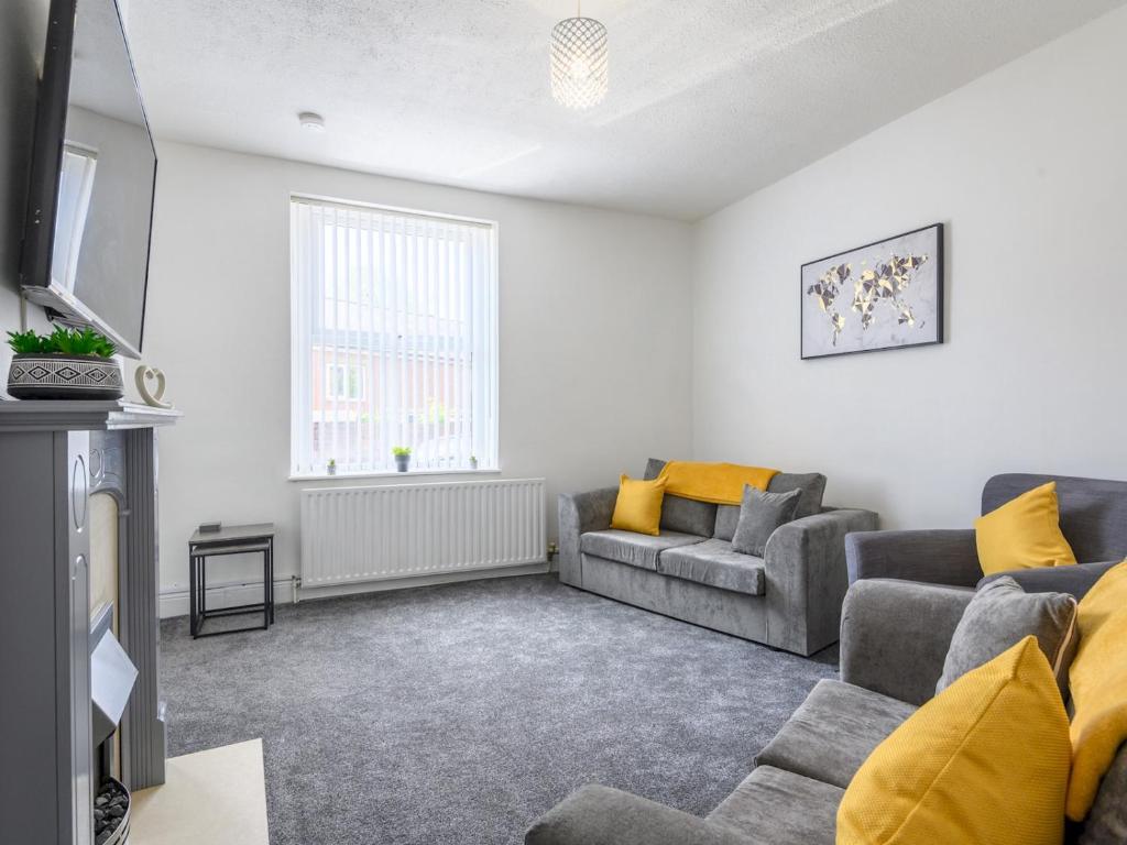 a living room with two couches and a tv at Spacious Oasis - Perfect for Large FamiliesGroups - Pass the Keys in Morley