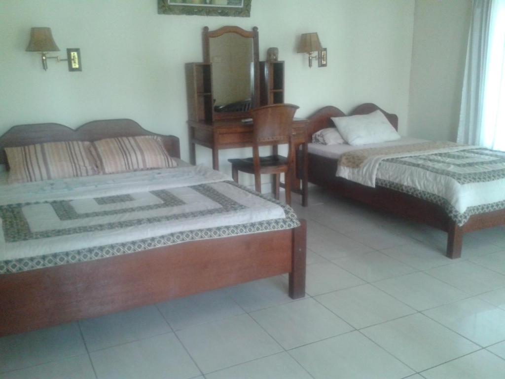 Postel nebo postele na pokoji v ubytování Indraprastha Ubud Home Stay