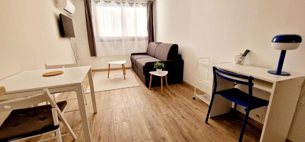 un petit salon avec un canapé et une table dans l'établissement 1 Le Saint Joseph studio with AC in the city center of Antibes, à Antibes