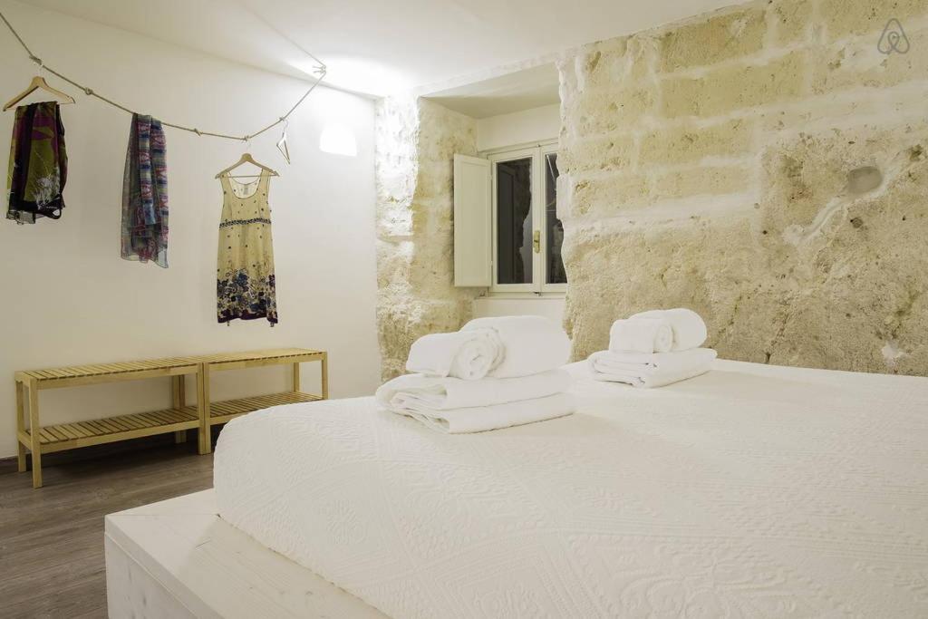 Postel nebo postele na pokoji v ubytování Il Vento dei Sassi