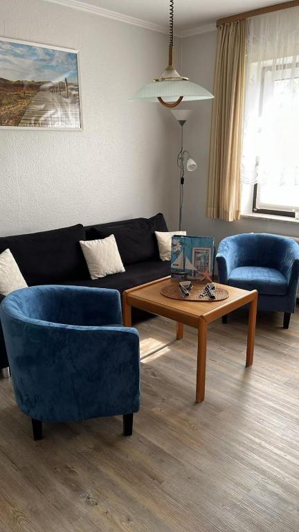 a living room with a couch and a coffee table at Seerose in Wittdün