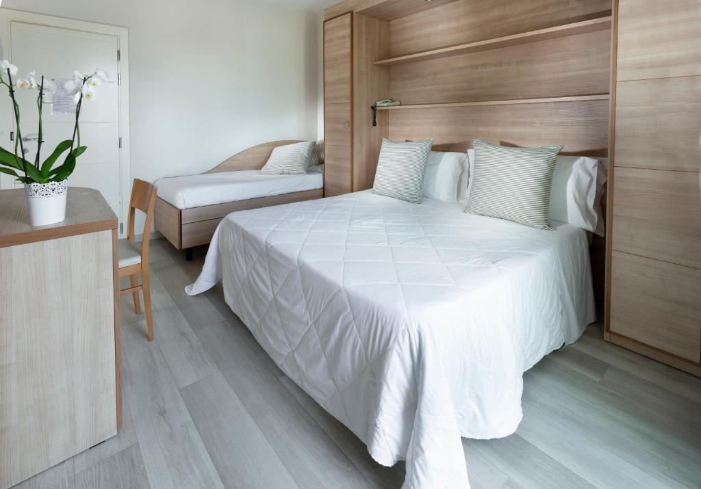 Postel nebo postele na pokoji v ubytování Hotel Giulietta