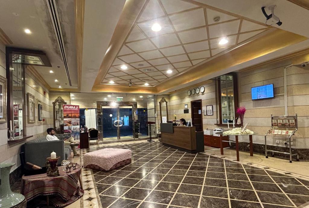 a lobby of a store with a person sitting in a chair at Al Raya Hotel Apartments in Dubai