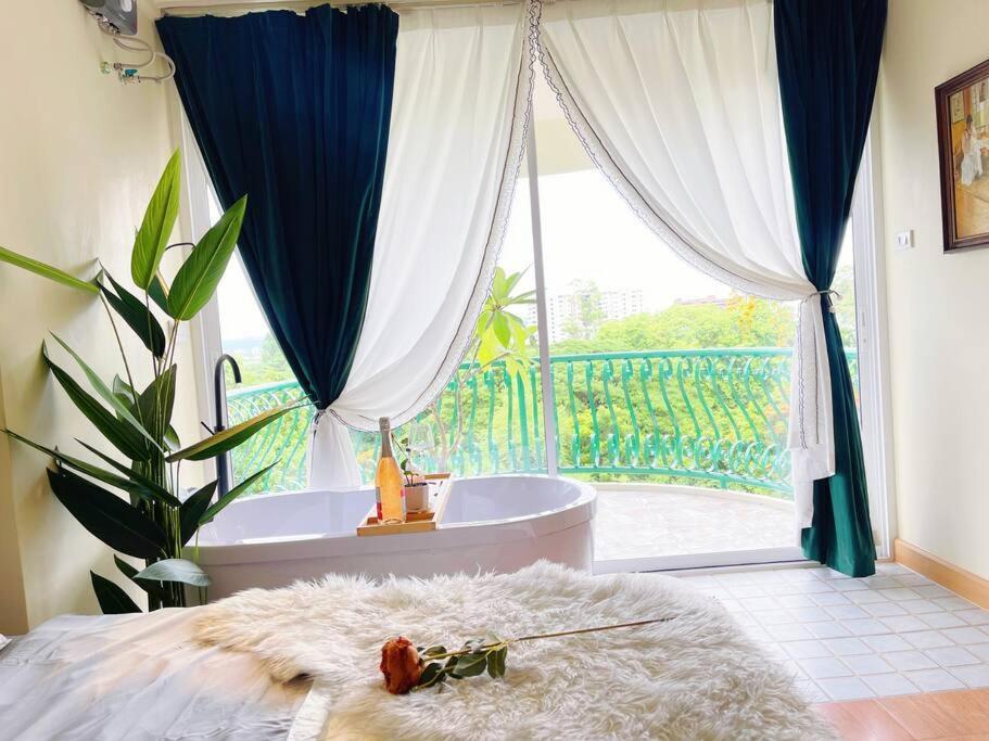 a bedroom with a bath tub and a large window at 912 Good view &2 minutes walk to one Nimman Maya in Chiang Mai