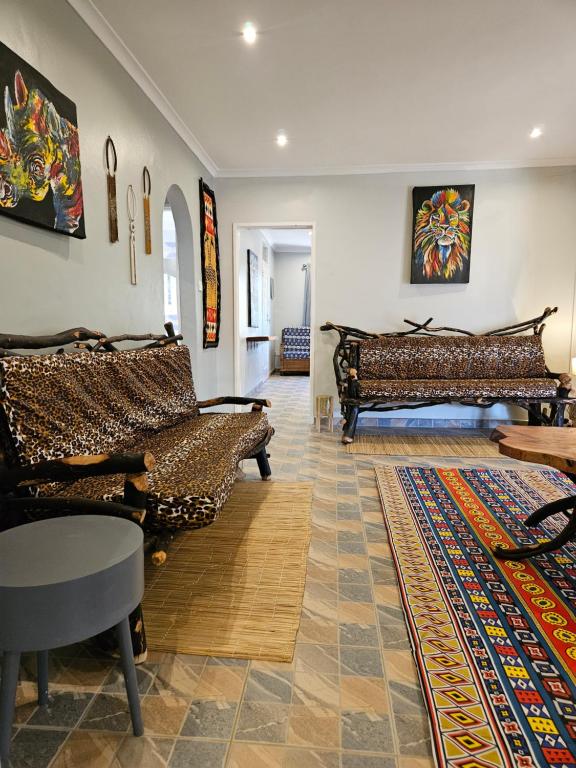 a living room with two couches and a rug at StoneWoodGrey in Harare