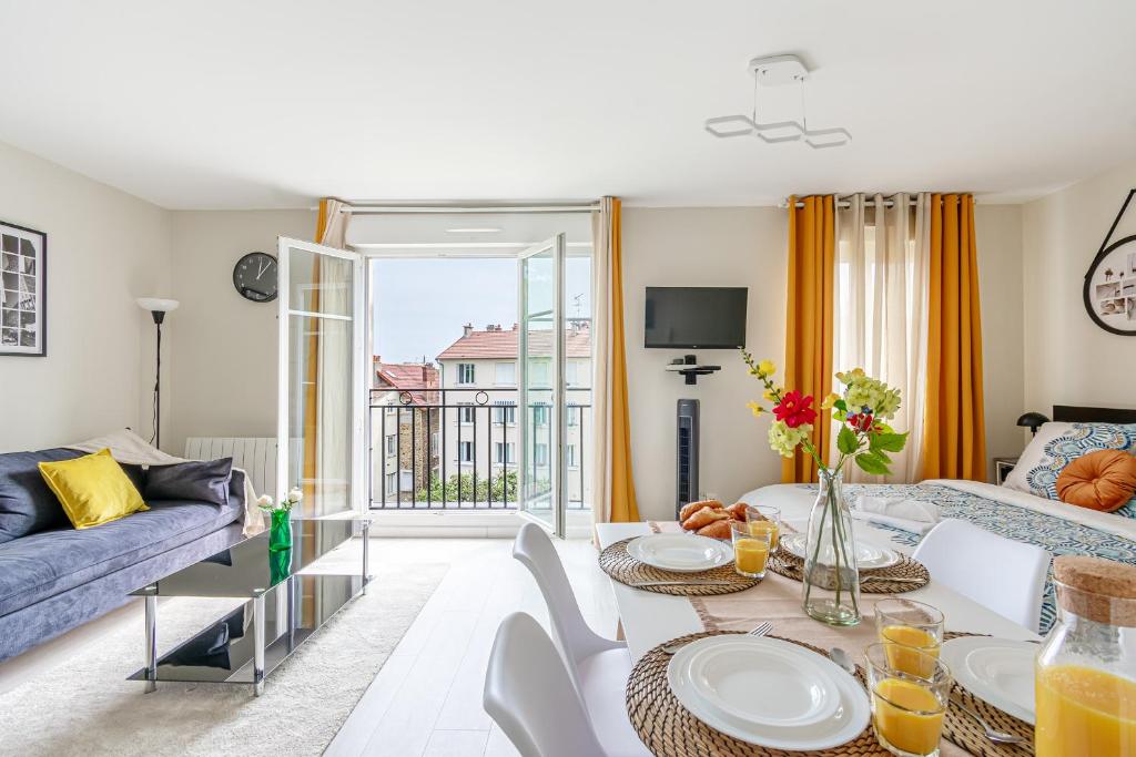 un salon avec une table et un canapé dans l'établissement CosyHome - Appartement CDG Paris Nord & Parc des Expos - Parking gratuit, à Aulnay-sous-Bois