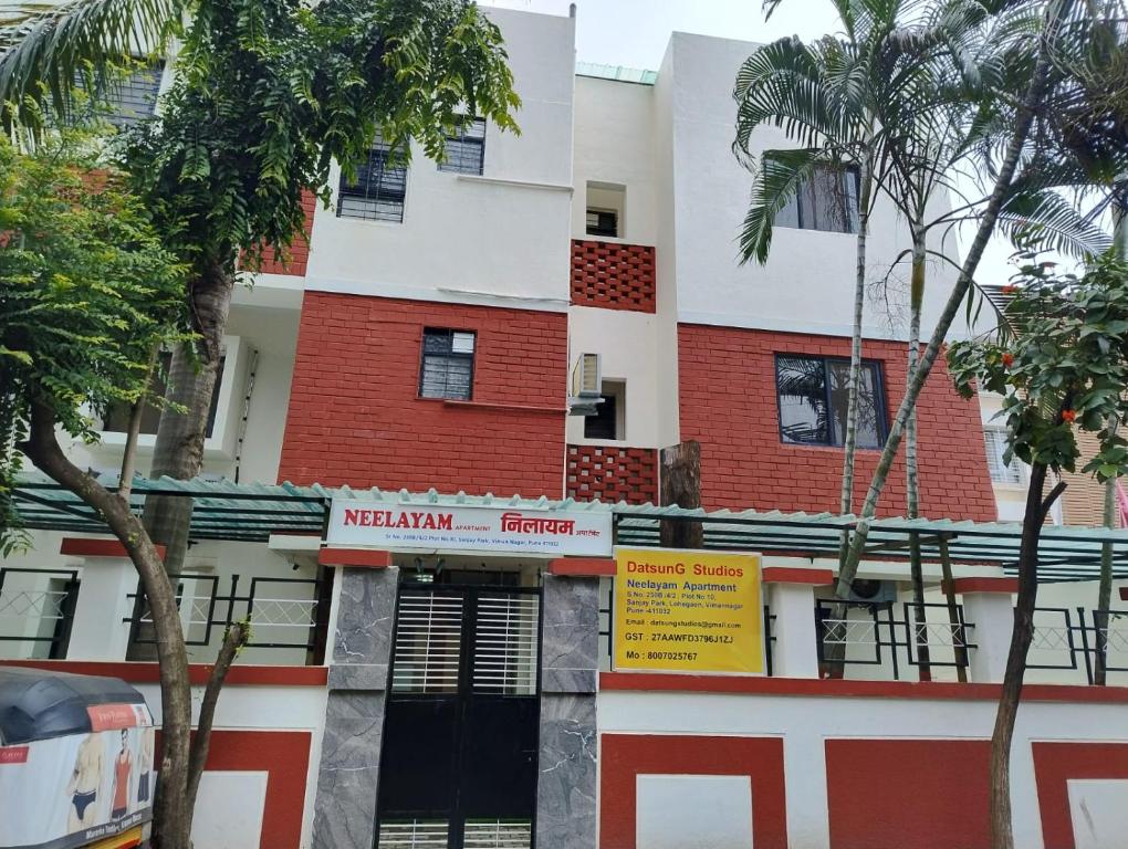 a building with a sign in front of it at DatsunG Studios Near Pune Airport in Pune