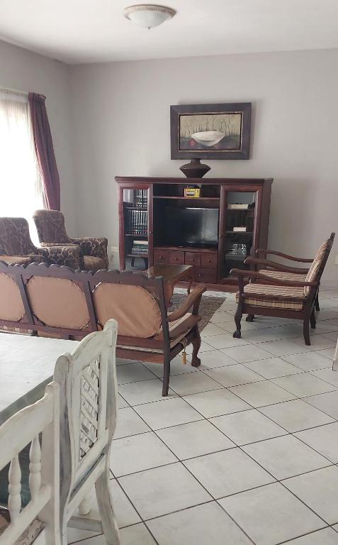 a living room with a couch and a tv at Brits Contractors Accommodation in Brits