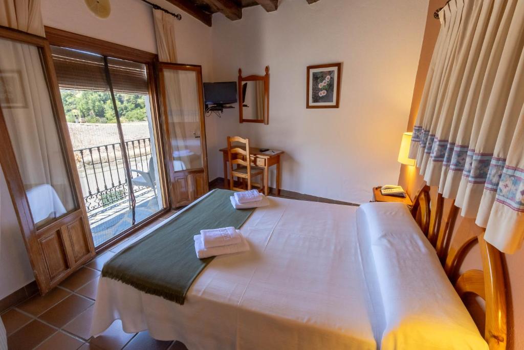 Postel nebo postele na pokoji v ubytování Hotel La Fragua I