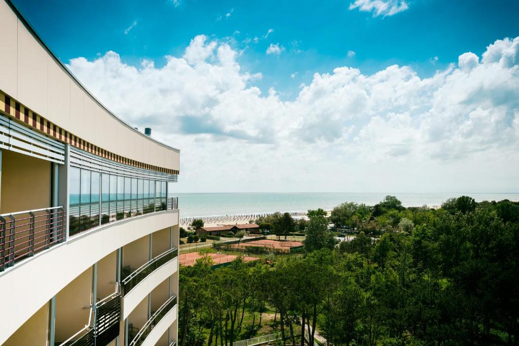 a view of the beach from the balcony of a building at Laguna Park Hotel 4Superior in Bibione