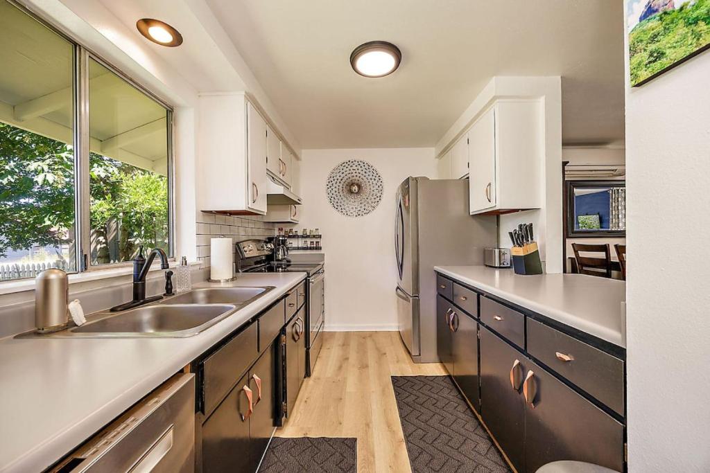 a kitchen with a sink and a refrigerator at Lanka Rose House by WanderLodges in Phoenix
