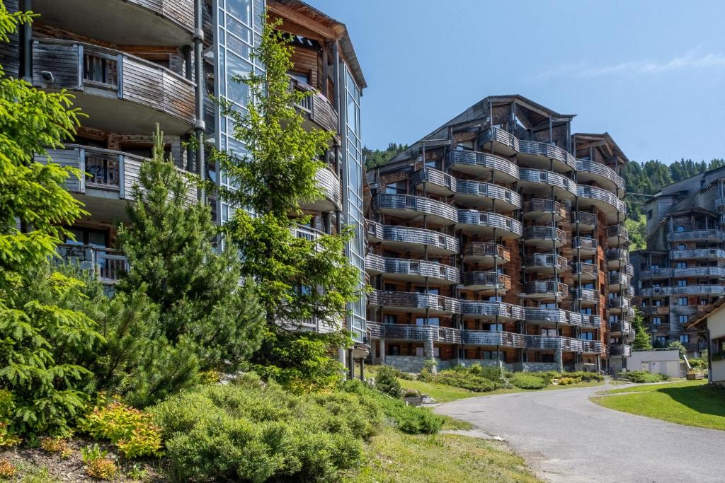 two tall apartment buildings next to a road at Résidence Pierre & Vacances Atria-Crozats in Avoriaz