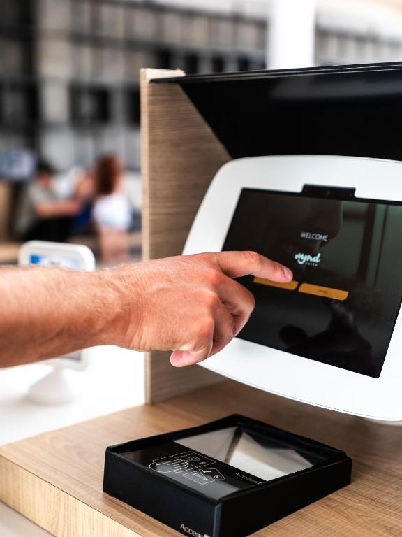 a hand is pointing at an electronic device at MYND Yaiza in Playa Blanca