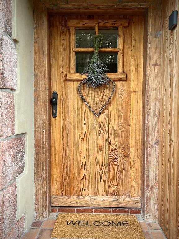 a wooden door with a plant on it at Little Cottage No.100 in Vidochov