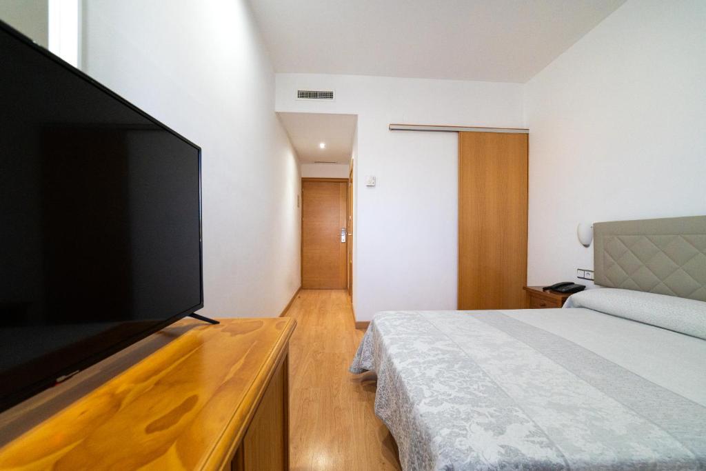 Postel nebo postele na pokoji v ubytování Hotel Puerta de Cazorla