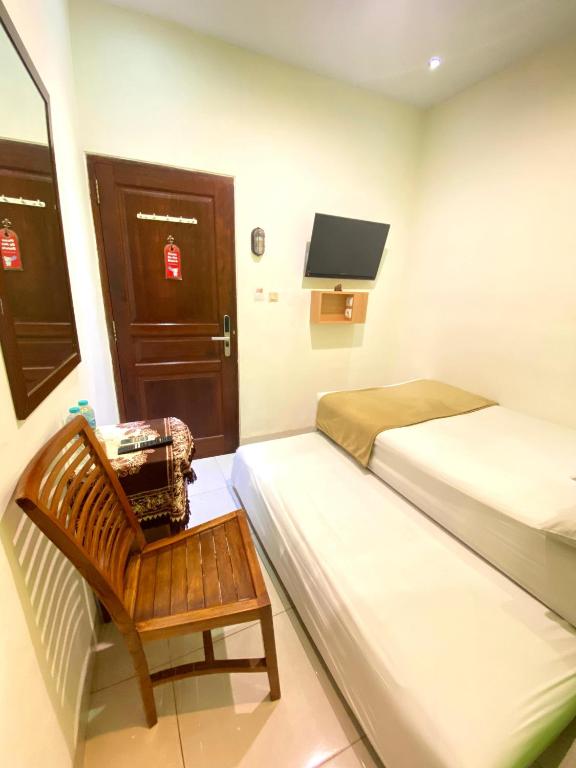 Postel nebo postele na pokoji v ubytování Cabin Hotel Bhayangkara