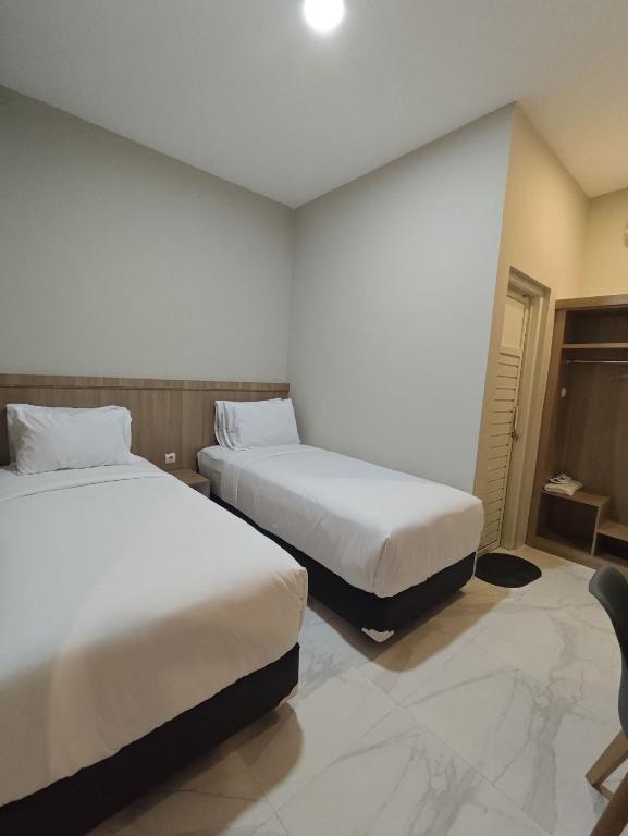 Postel nebo postele na pokoji v ubytování El Nipa Hotel Labuan Bajo