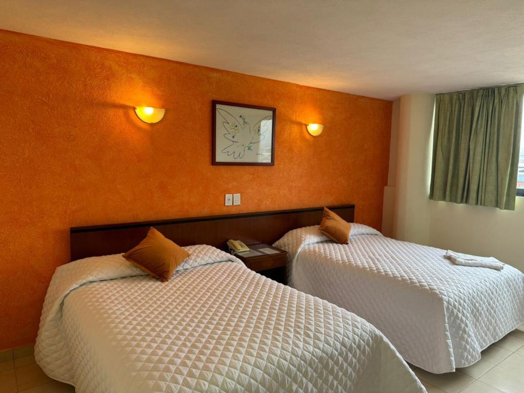 Postel nebo postele na pokoji v ubytování Hotel Bello Cordoba