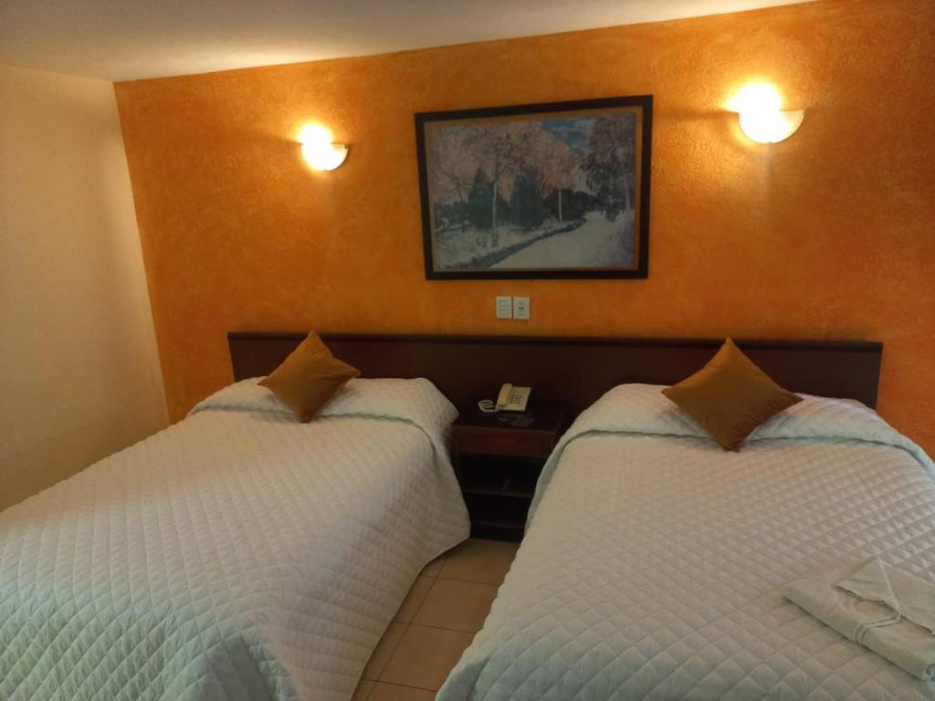 Postel nebo postele na pokoji v ubytování Hotel Bello Cordoba