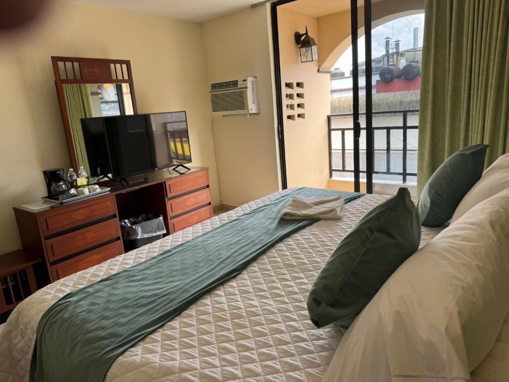 Postel nebo postele na pokoji v ubytování Hotel Bello Cordoba