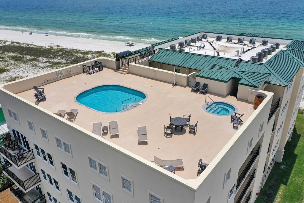 an aerial view of a building with a swimming pool and the beach at Sharkey's by Pristine Properties Vacation Rentals in Cape San Blas