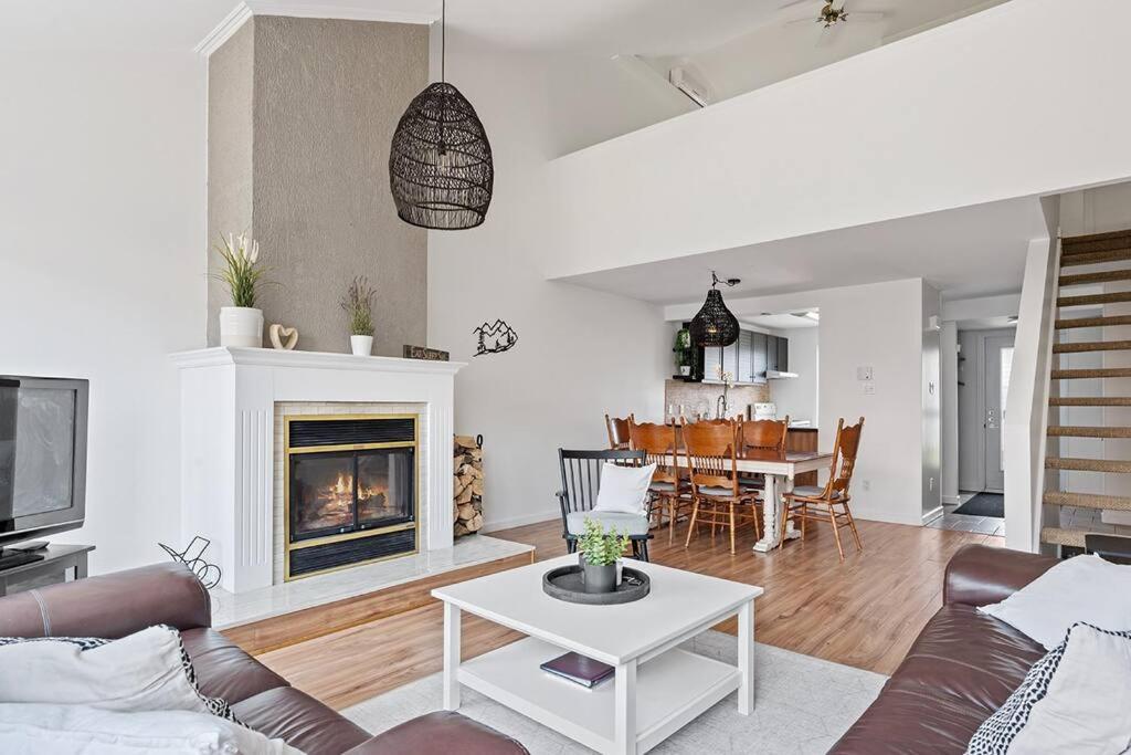 a living room with a couch and a table at Unité 26 - Ski-in Ski-out in Beaupré