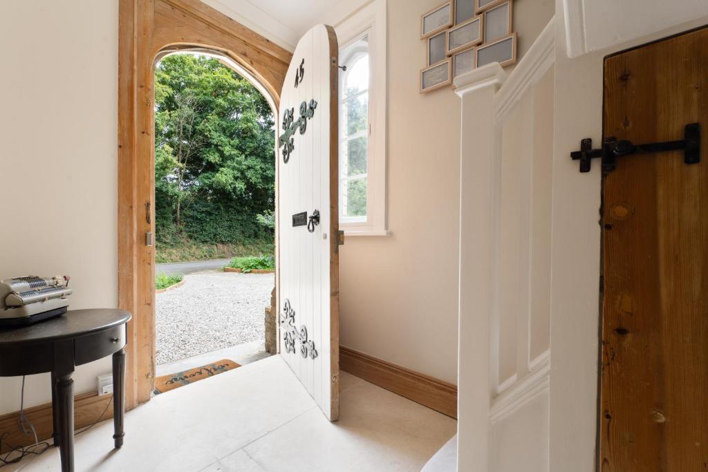 a hallway with an open door and a table at Wimborne Hideaway in Bournemouth