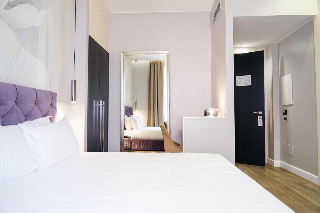 Postel nebo postele na pokoji v ubytování The Unique Hotel