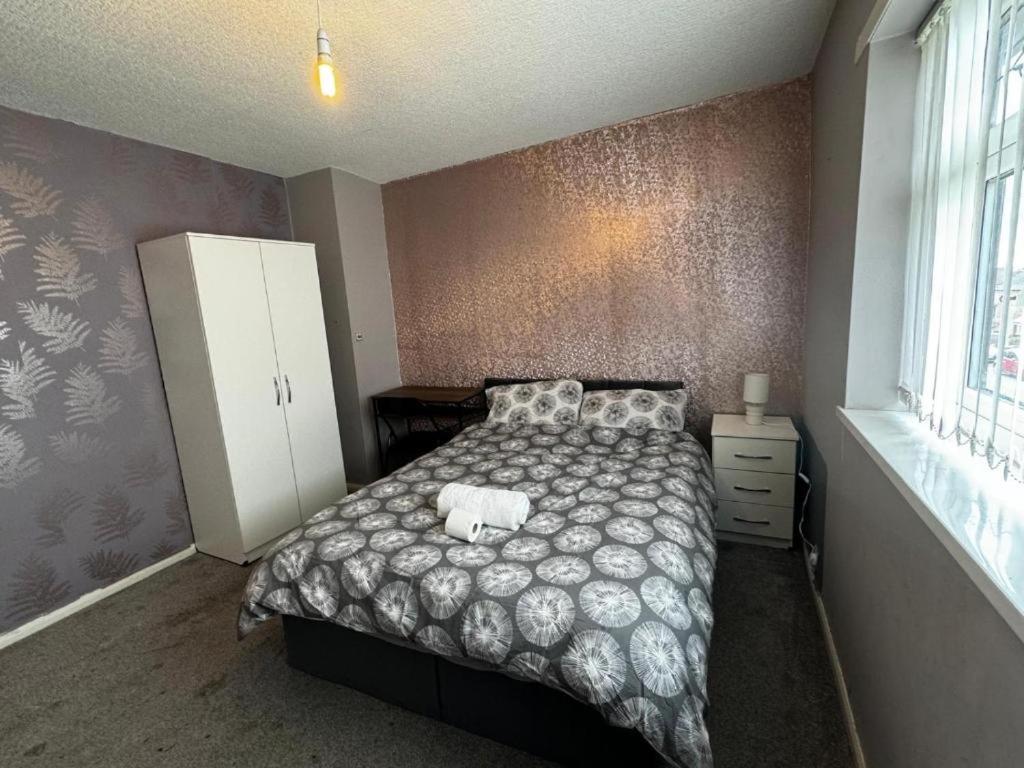 a bedroom with a large bed and a white cabinet at Double Room XX Manchester in Manchester