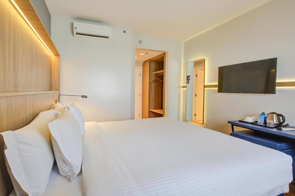 Cama o camas de una habitación en Hampton by Hilton Guarulhos Airport