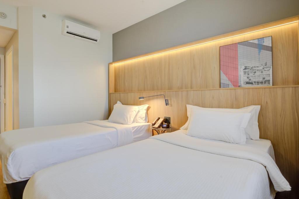 Cama o camas de una habitación en Hampton by Hilton Guarulhos Airport
