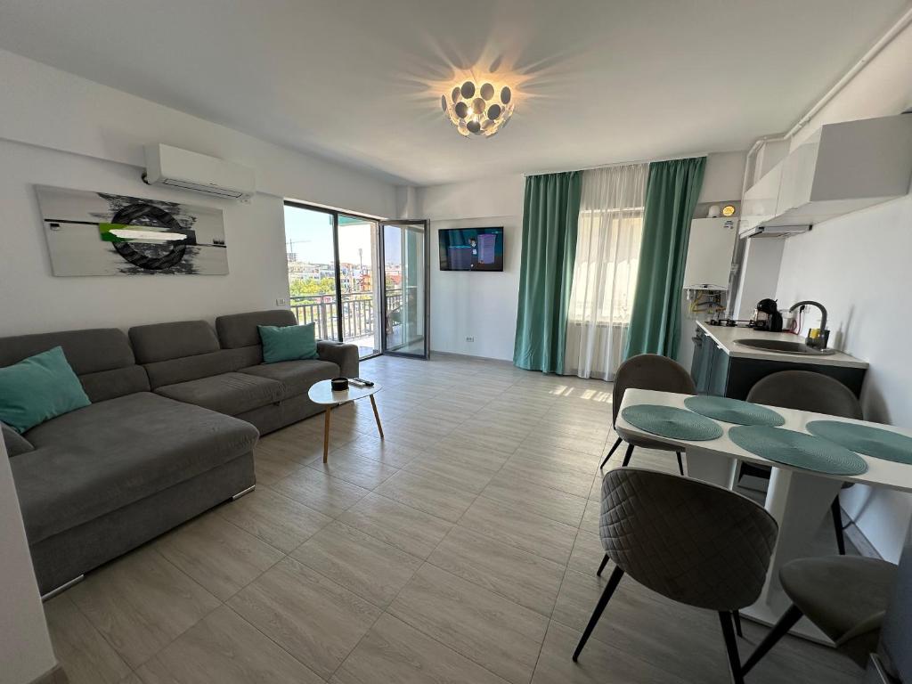 a living room with a couch and a table at Apartament Anne Marie - Ibo Residence in Mamaia Nord