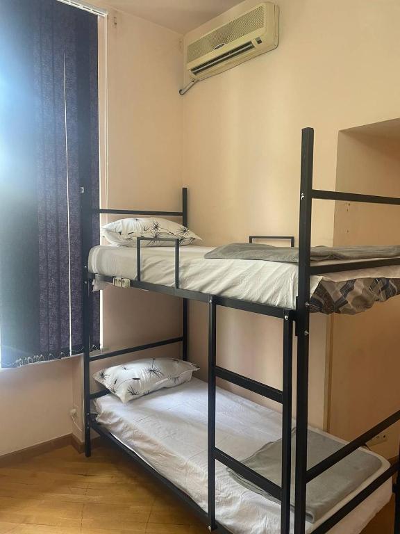 Postel nebo postele na pokoji v ubytování Olympic Hostel