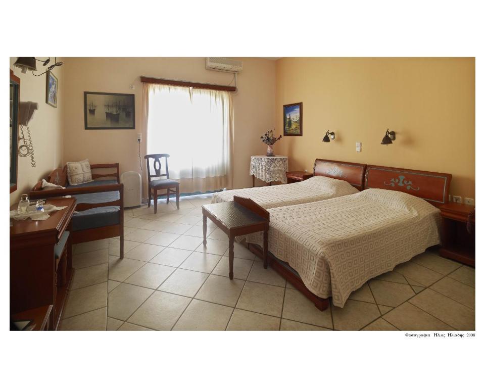 Postel nebo postele na pokoji v ubytování Apollon Hotel