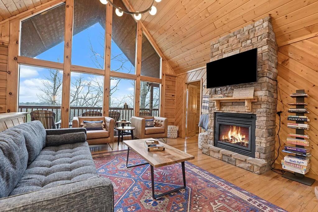 a living room with a couch and a fireplace at Pitch Perfect in Sevierville