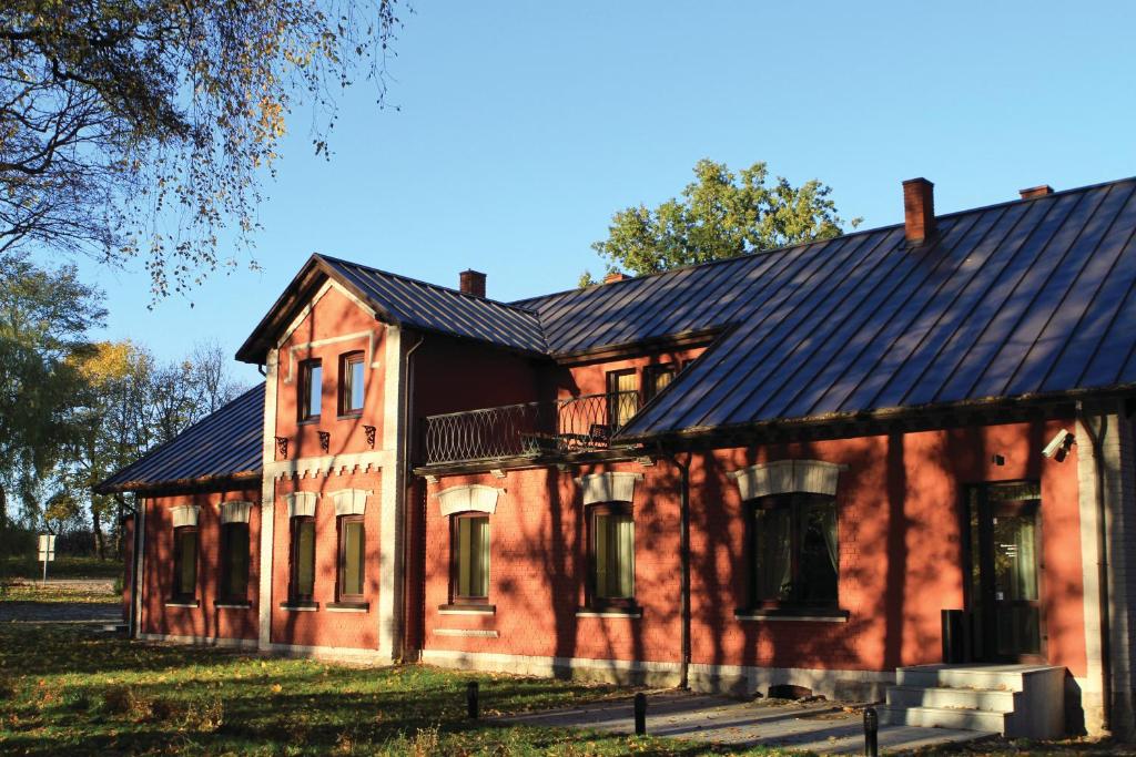 una antigua casa de ladrillo rojo con techo negro en Grafo Zubovo Hotel & SPA, en Bubiai