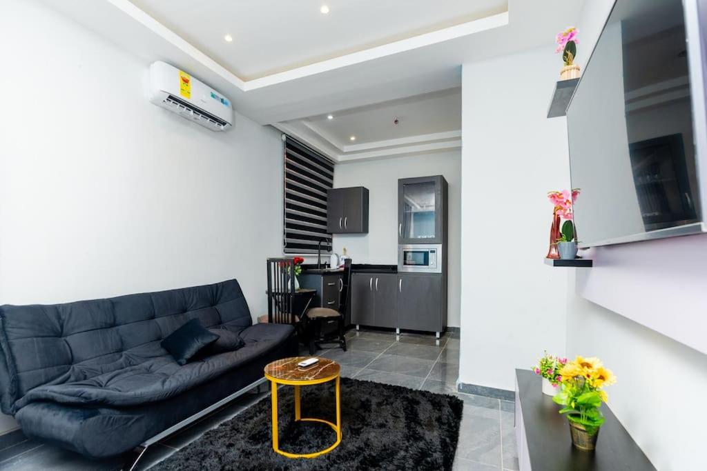a living room with a couch and a table at Stay with Peace on Spintex road in Baatsona