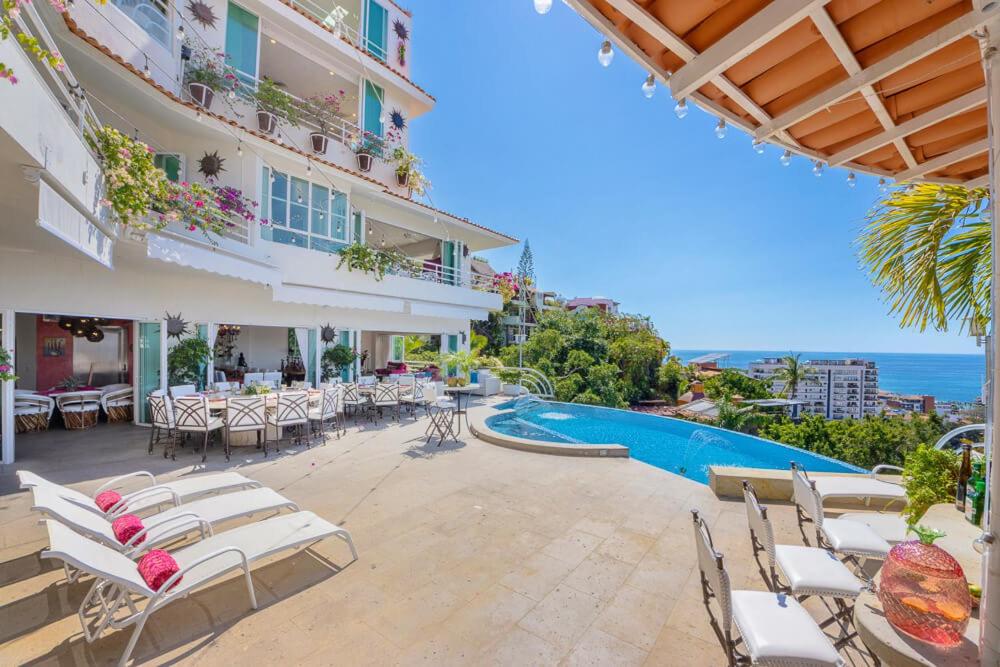 a hotel patio with chairs and a swimming pool at Casa Ivonne in Puerto Vallarta