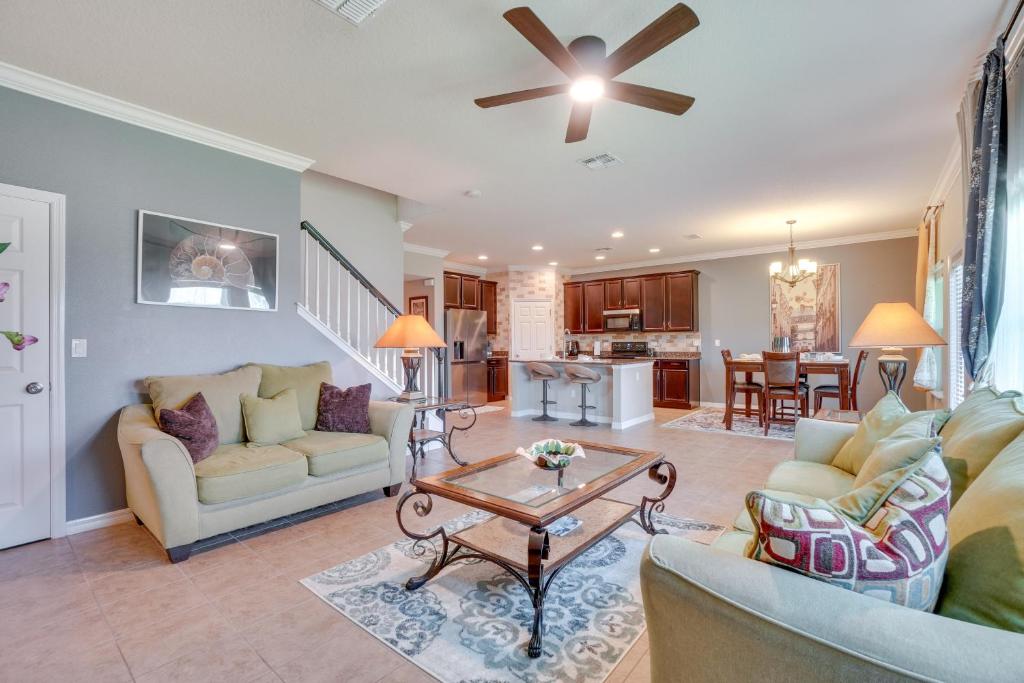 a living room with two couches and a table at WFH, Relax and Enjoy At-Home Comforts in Orlando in Kissimmee