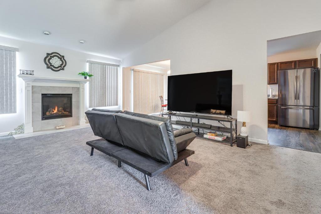 a living room with a tv and a fireplace at Michigan Home with Yard, 3 Mi to Detroit Airport in Romulus