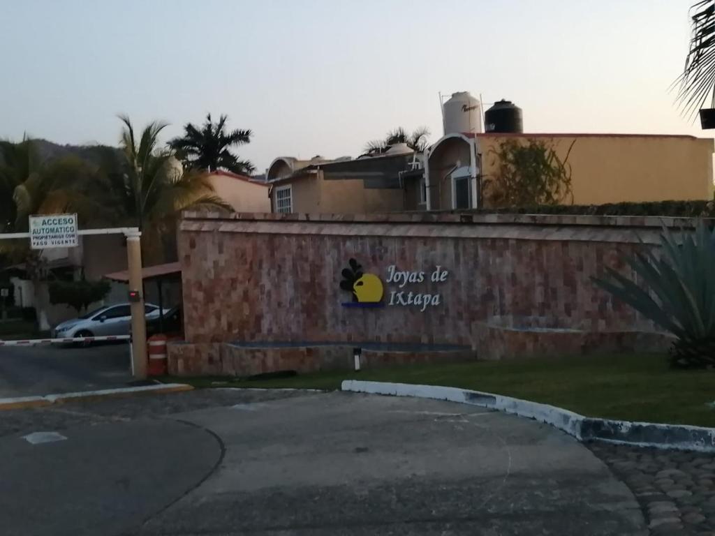 a wall with a sign that reads love of forever at Casa Cayo in Ixtapa