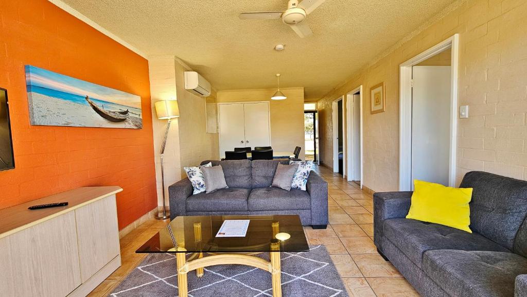 a living room with two couches and a table at Riverview Holiday Apartment 49 - Kalbarri WA in Kalbarri